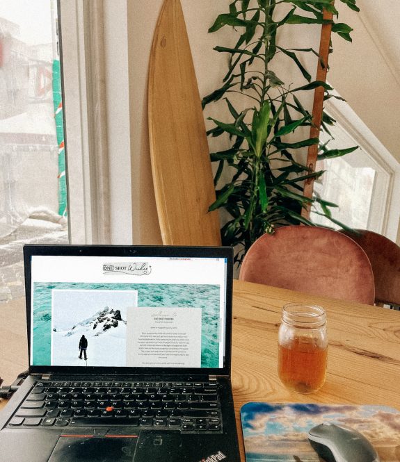 Digital nomad workspace with laptop showcasing travel services from a professional travel advisor and marketing consultant. Ideal setup for those who work from anywhere, embodying the freedom and flexibility of remote work and international travel.
